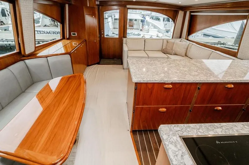 Trailer Trash Yacht Photos Pics Luxurious interior of 2021 Viking 58 Convertible yacht with elegant wood finishes and spacious seating.