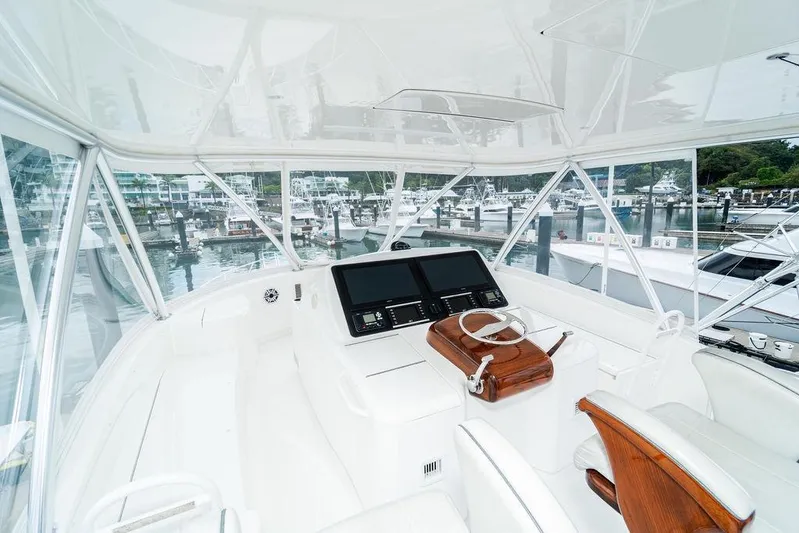 Trailer Trash Yacht Photos Pics Helm of 2021 Viking 58 Convertible yacht with dual screens and wooden accents.