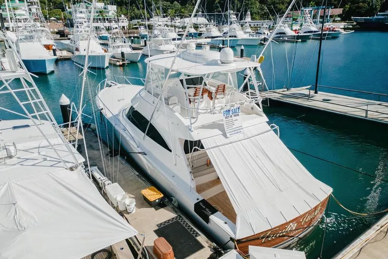 Trailer Trash Yacht Photos Pics 2021 Viking 58 Convertible yacht docked in marina, for sale sign visible.