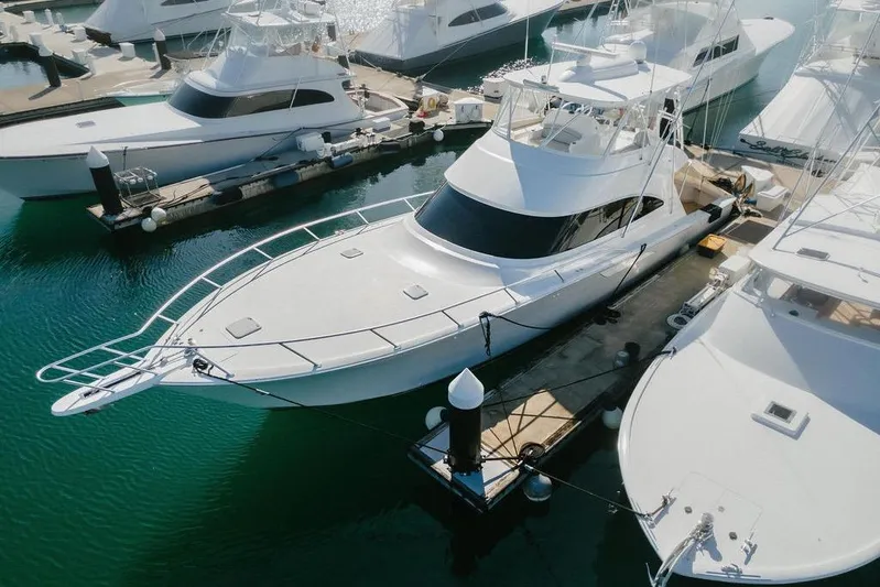 Trailer Trash Yacht Photos Pics 2021 Viking 58 Convertible yacht docked at marina, surrounded by other boats.