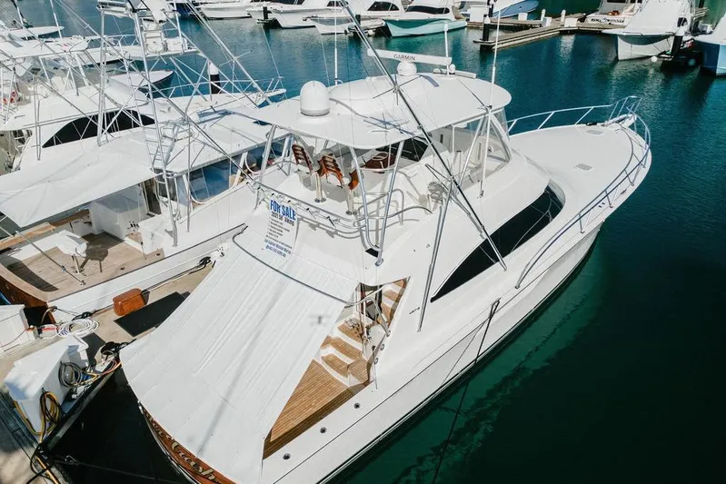 Trailer Trash Yacht Photos Pics 2021 Viking 58 Convertible yacht docked at marina, for sale sign visible.