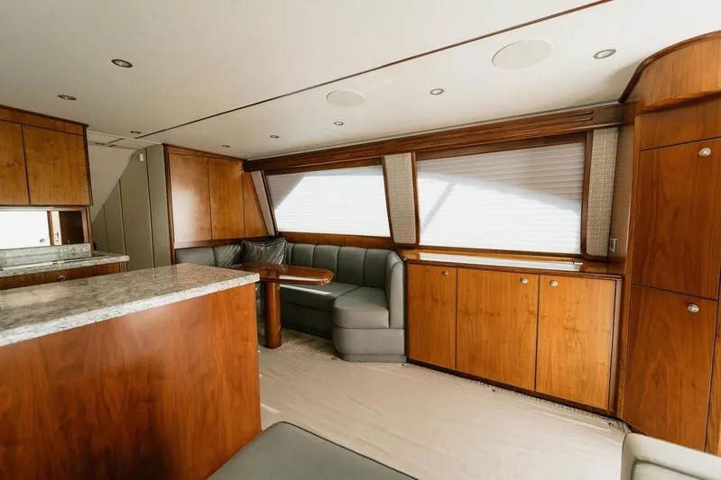 Trailer Trash Yacht Photos Pics Luxurious interior of 2021 Viking 58 Convertible yacht with wood cabinetry and plush seating.