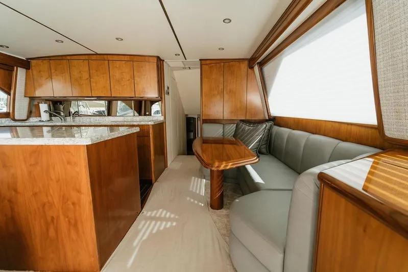 Trailer Trash Yacht Photos Pics Luxurious interior of 2021 Viking 58 Convertible yacht with wood finishes and plush seating.