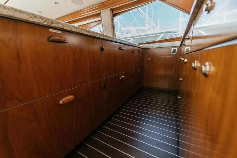 Trailer Trash Yacht Photos Pics Luxurious wooden cabinetry inside a 2021 Viking 58 Convertible yacht kitchen.