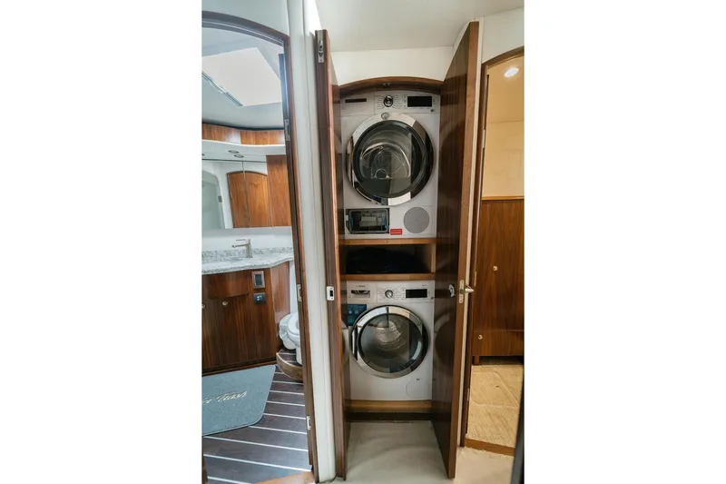 Trailer Trash Yacht Photos Pics Laundry area with stacked washer and dryer in 2021 Viking 58 Convertible yacht.