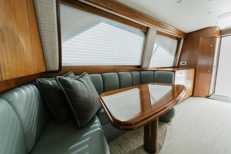 Trailer Trash Yacht Photos Pics Luxurious interior of 2021 Viking 58 Convertible yacht with elegant wood finishes and plush seating.