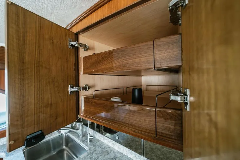 Trailer Trash Yacht Photos Pics Open wooden cabinet in 2021 Viking 58 Convertible yacht kitchen.
