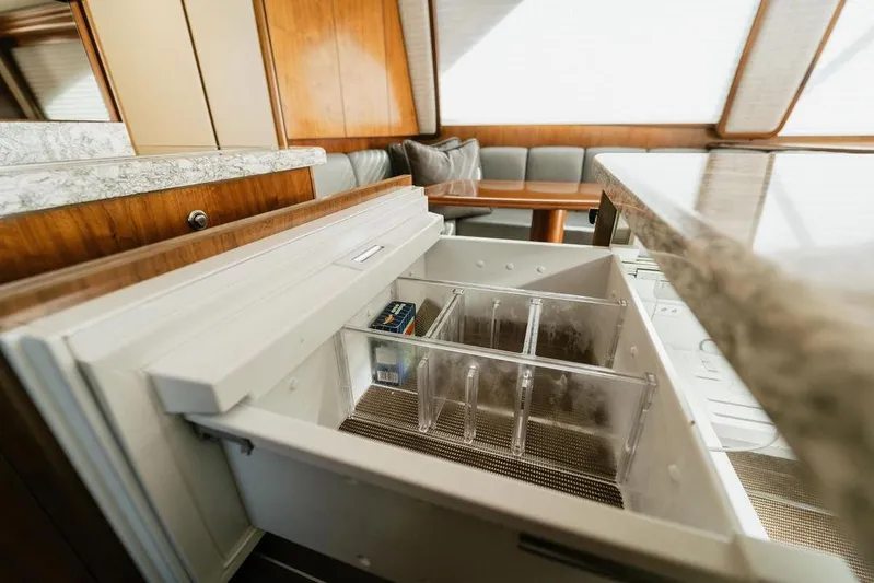 Trailer Trash Yacht Photos Pics Interior of 2021 Viking 58 Convertible yacht with open drawer and seating area.