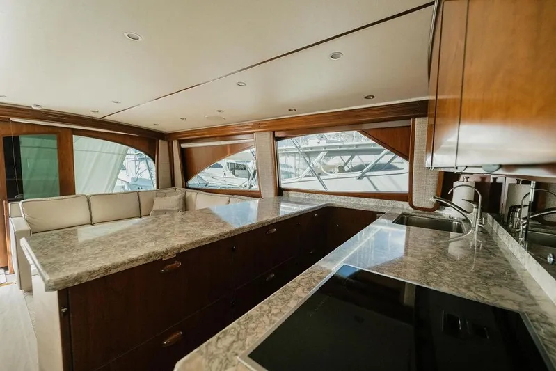 Trailer Trash Yacht Photos Pics Luxurious interior of 2021 Viking 58 Convertible yacht with modern kitchen and seating area.
