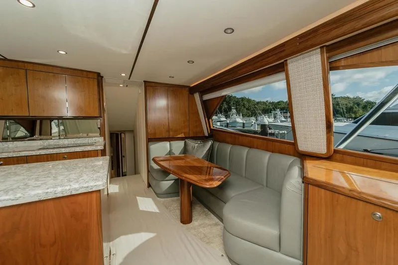 Trailer Trash Yacht Photos Pics Luxurious interior of 2021 Viking 58 Convertible yacht with wood finishes and plush seating.