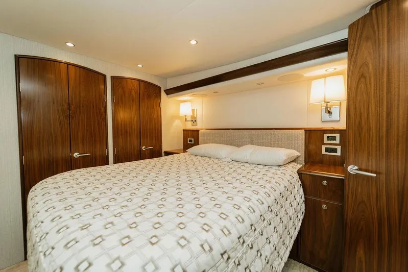 Trailer Trash Yacht Photos Pics Luxurious bedroom interior of 2021 Viking 58 Convertible yacht with elegant wood finishes.