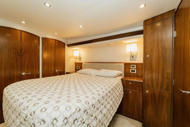 Trailer Trash Yacht Photos Pics Luxurious bedroom interior of 2021 Viking 58 Convertible yacht with elegant wood finish.
