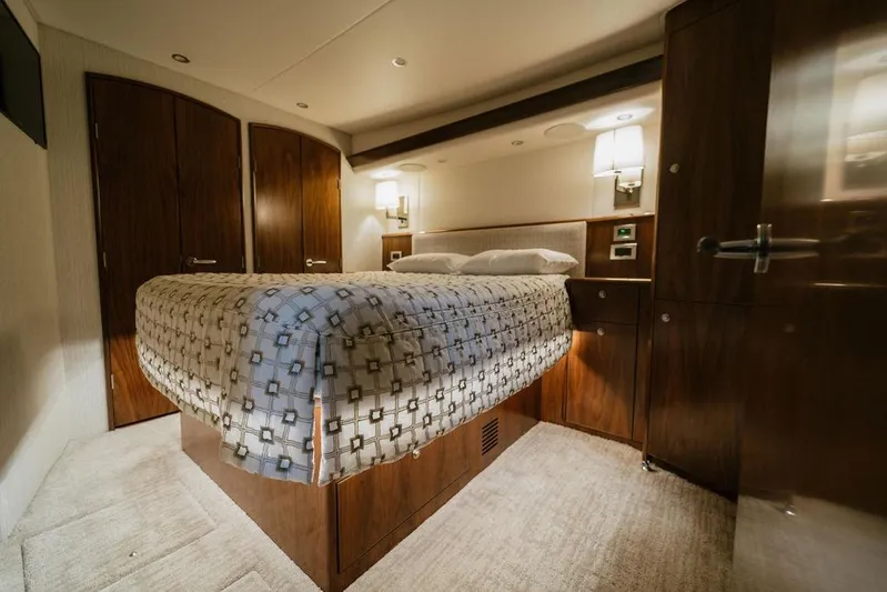 Trailer Trash Yacht Photos Pics Luxurious bedroom interior of 2021 Viking 58 Convertible yacht with elegant wood finishes.
