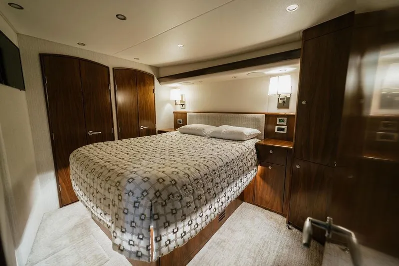 Trailer Trash Yacht Photos Pics Luxurious bedroom interior of 2021 Viking 58 Convertible yacht with elegant wood finishes.