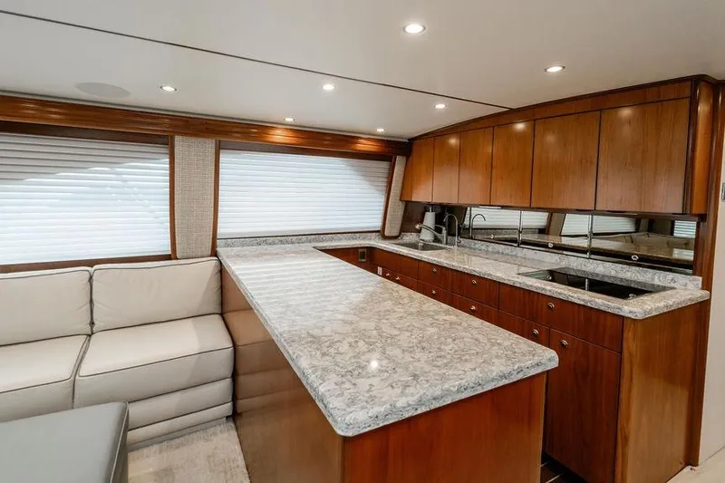 Trailer Trash Yacht Photos Pics Luxurious interior of 2021 Viking 58 Convertible yacht with modern kitchen and seating area.