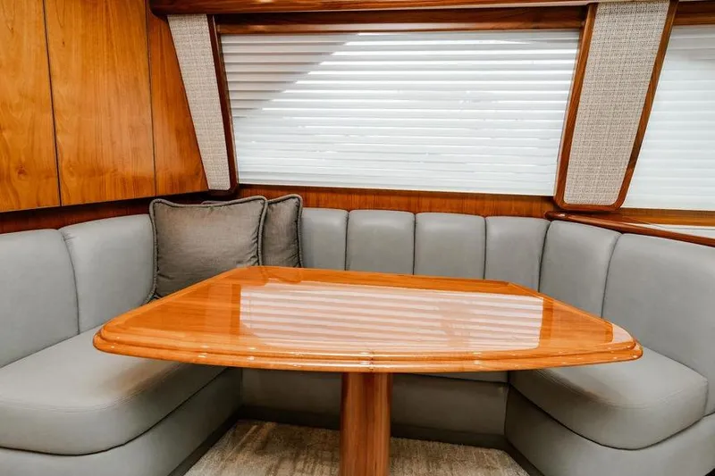 Trailer Trash Yacht Photos Pics Luxurious interior of 2021 Viking 58 Convertible yacht with elegant wood table and plush seating.