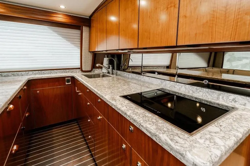 Trailer Trash Yacht Photos Pics Luxurious kitchen interior of 2021 Viking 58 Convertible yacht with sleek countertops and modern appliances.