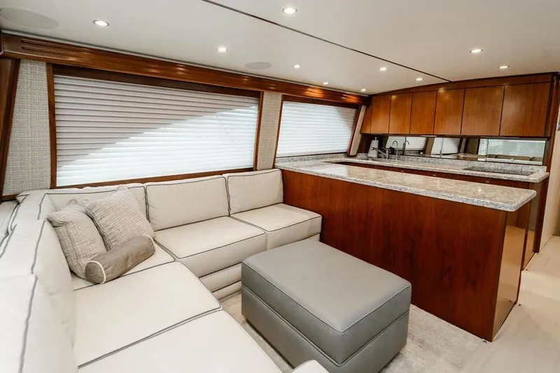 Trailer Trash Yacht Photos Pics Luxurious interior of 2021 Viking 58 Convertible yacht with modern kitchen and cozy seating area.