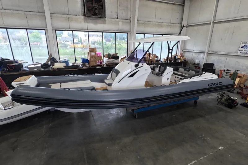  Yacht Photos Pics 2025 Grand Inflatables G850 boat in a warehouse setting, showcasing sleek design and modern features.