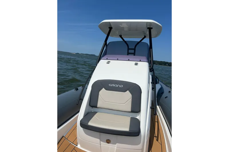  Yacht Photos Pics 2025 Grand Inflatables G850 boat on water, featuring sleek seating and modern design.