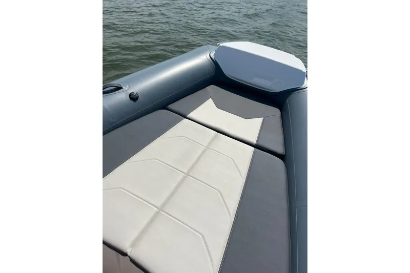  Yacht Photos Pics 2025 Grand Inflatables G850 boat with sleek seating on calm water.