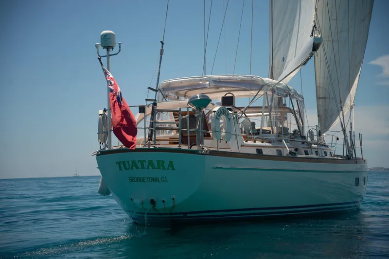 Tuatara Yacht Photos Pics Little Harbor 63 sailboat from 1983, named "Tuatara," sailing in clear blue waters.