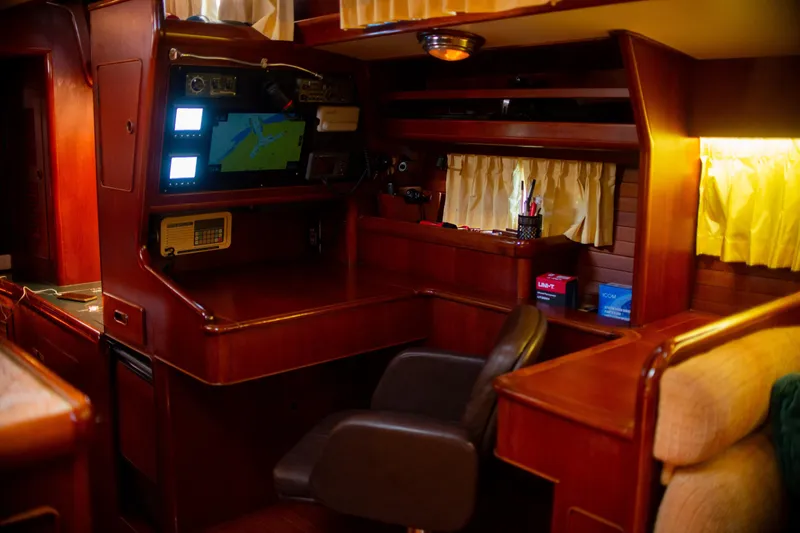 Tuatara Yacht Photos Pics Interior of 1983 Little Harbor 63 yacht with navigation station and wooden furnishings.
