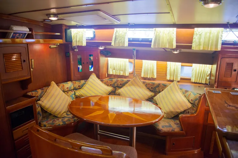 Tuatara Yacht Photos Pics Luxurious 1983 Little Harbor 63 yacht interior with cozy seating and elegant wooden table.