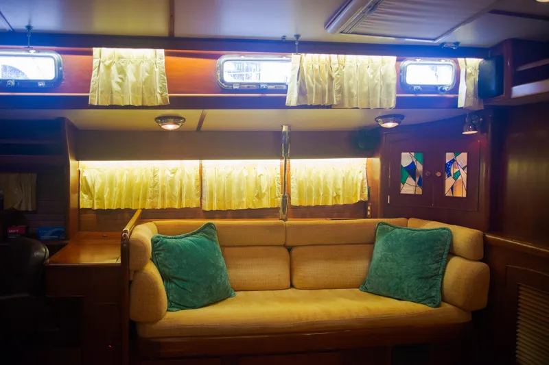 Tuatara Yacht Photos Pics Luxurious 1983 Little Harbor 63 yacht interior with cozy seating and elegant stained glass accents.