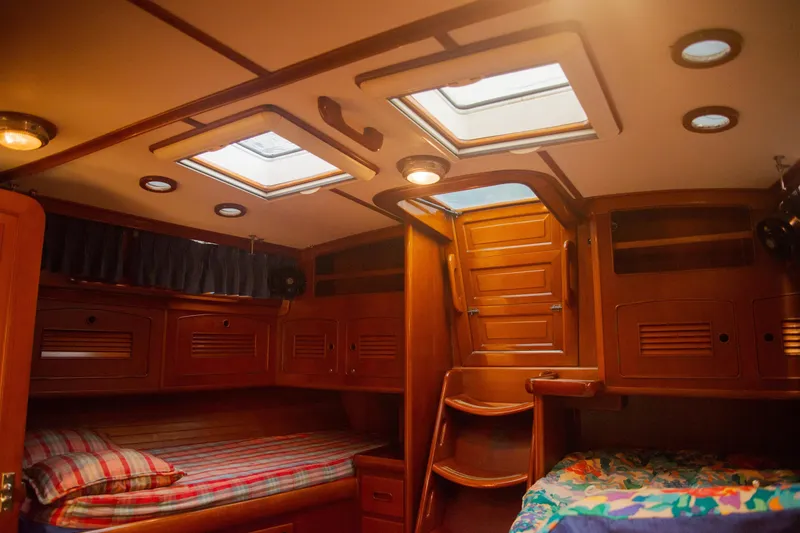 Tuatara Yacht Photos Pics Cozy cabin interior of 1983 Little Harbor 63 yacht with wooden finishes and skylights.