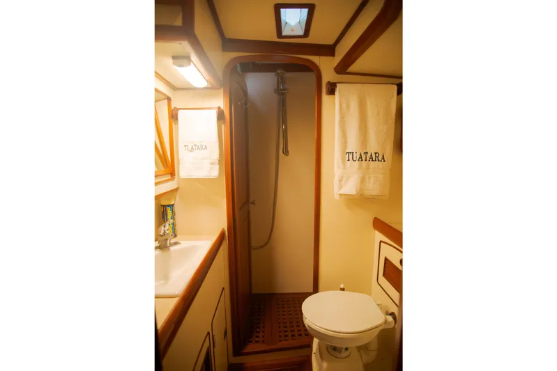 Tuatara Yacht Photos Pics Bathroom interior of 1983 Little Harbor 63 yacht, featuring shower and toilet.