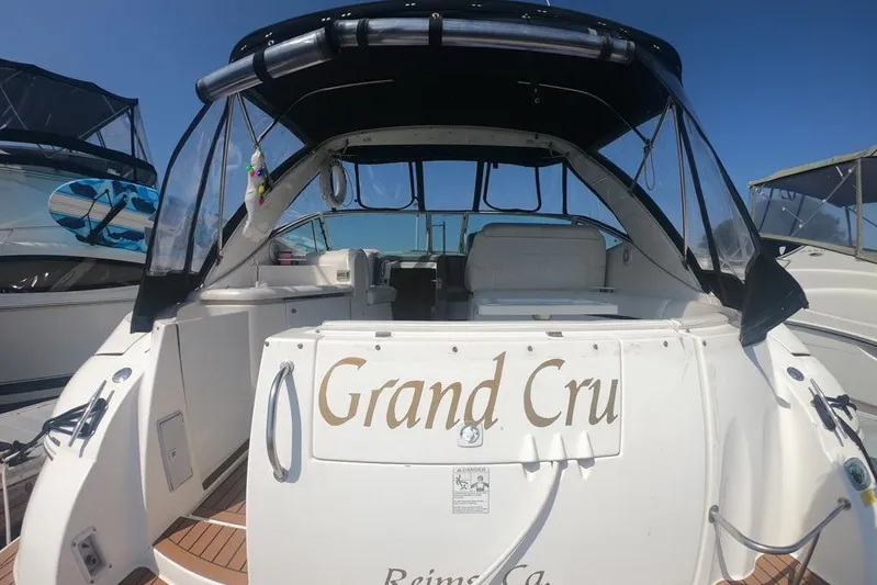 Grand Cru Yacht Photos Pics 2005 Cruisers Yachts 340 Express boat with "Grand Cru" name, docked under clear blue sky.