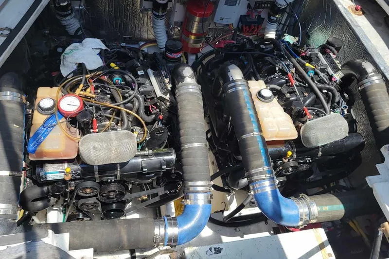 Grand Cru Yacht Photos Pics Engine compartment of a 2005 Cruisers Yachts 340 Express, featuring dual engines and hoses.