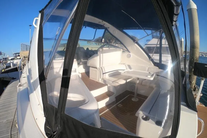 Grand Cru Yacht Photos Pics 2005 Cruisers Yachts 340 Express with enclosed cockpit and seating, docked at marina.