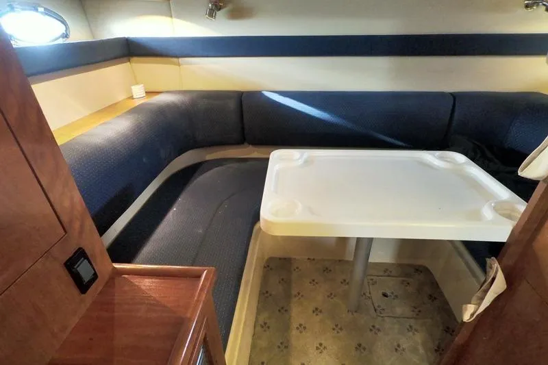 Grand Cru Yacht Photos Pics 2005 Cruisers Yachts 340 Express interior with blue seating and white table.