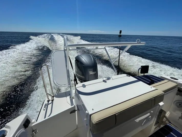  Yacht Photos Pics 2022 Ranger Tugs R-27 cruising on open water, showcasing powerful outboard motor.