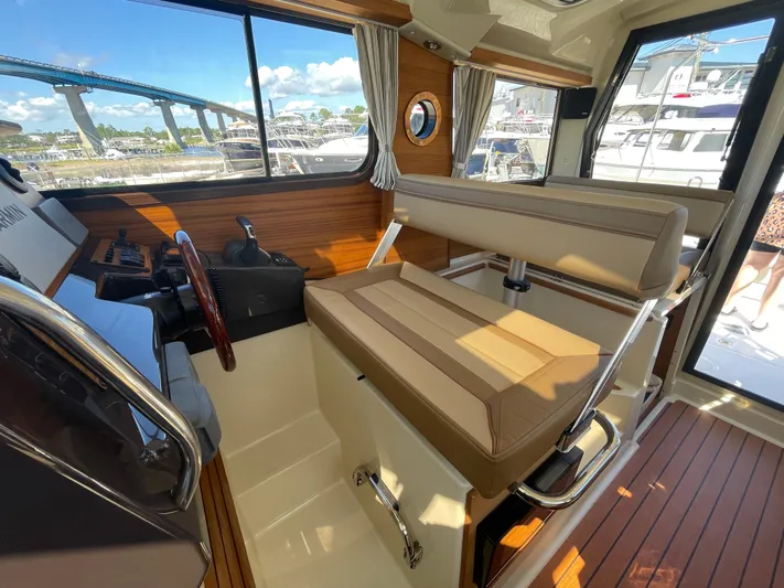  Yacht Photos Pics Interior of 2022 Ranger Tugs R-27 boat with helm and seating area.