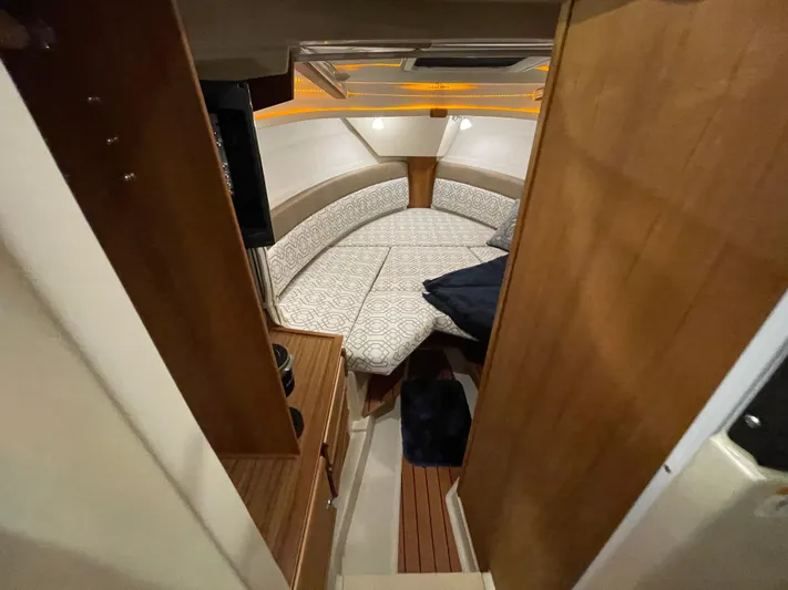  Yacht Photos Pics 2022 Ranger Tugs R-27 cabin interior with cozy seating and wood accents.