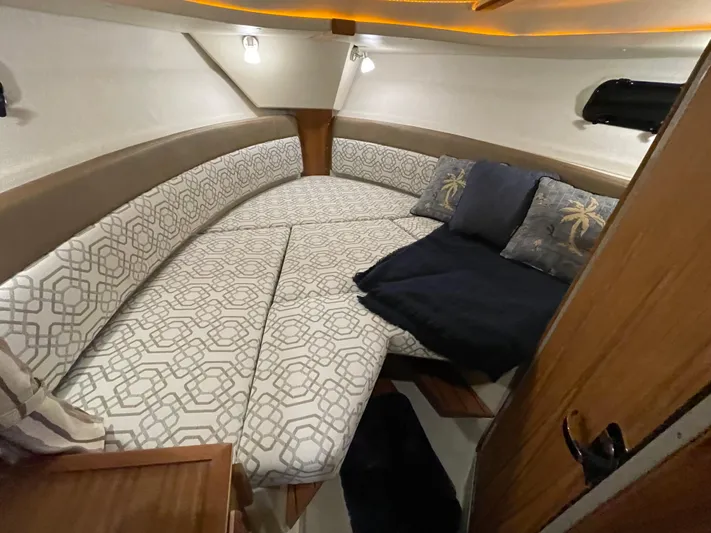  Yacht Photos Pics 2022 Ranger Tugs R-27 cabin interior with patterned cushions and ambient lighting.