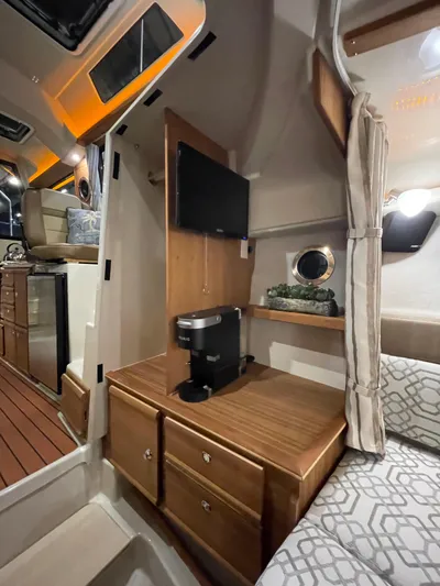  Yacht Photos Pics Interior of 2022 Ranger Tugs R-27 with TV, coffee maker, and cozy seating area.