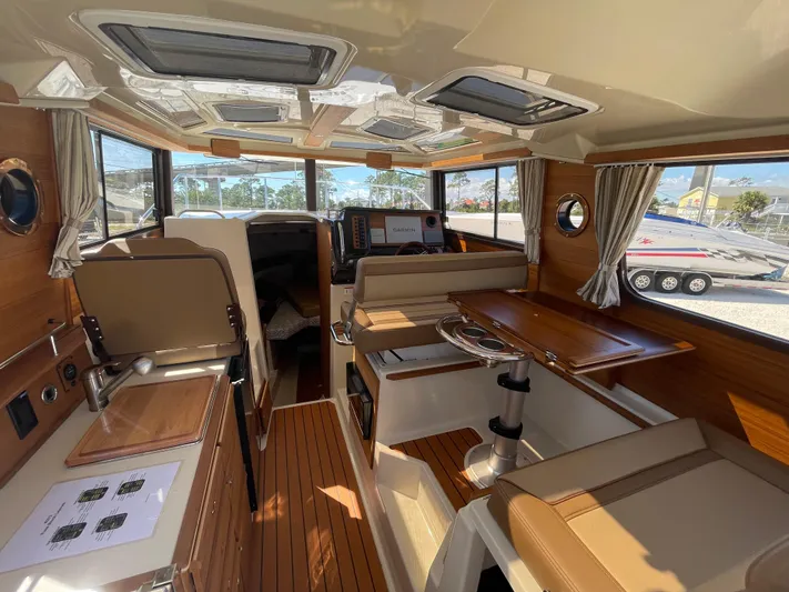  Yacht Photos Pics Interior of 2022 Ranger Tugs R-27 boat, featuring wood accents and modern amenities.