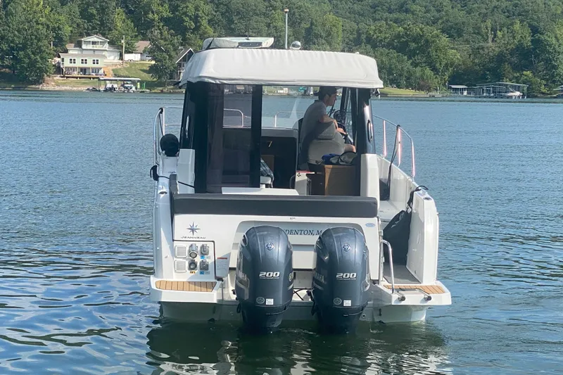  Yacht Photos Pics 2024 Jeanneau NC 895 boat on a lake with dual Yamaha engines.