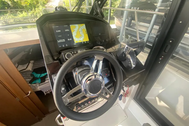  Yacht Photos Pics 2024 Jeanneau NC 895 helm with navigation display and steering wheel.