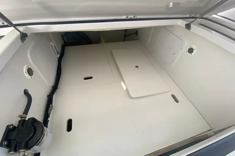  Yacht Photos Pics 2024 Jeanneau NC 895 storage compartment with white interior and access panels.