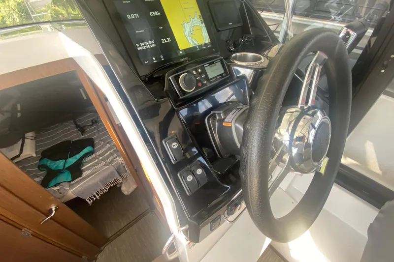  Yacht Photos Pics 2024 Jeanneau NC 895 helm with navigation display and cabin view.