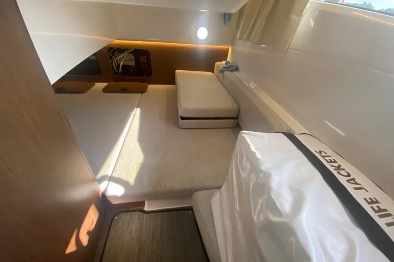  Yacht Photos Pics Interior cabin of 2024 Jeanneau NC 895 boat with seating and life jackets.