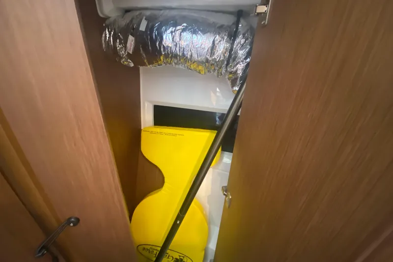  Yacht Photos Pics Interior view of 2024 Jeanneau NC 895 boat, featuring storage compartment and ventilation duct.