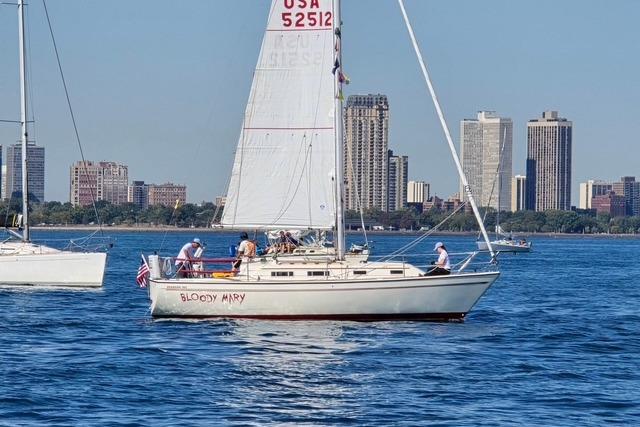Sailboat "Bloody Mary" on water, Pearson 303, 1986, city skyline in background.
