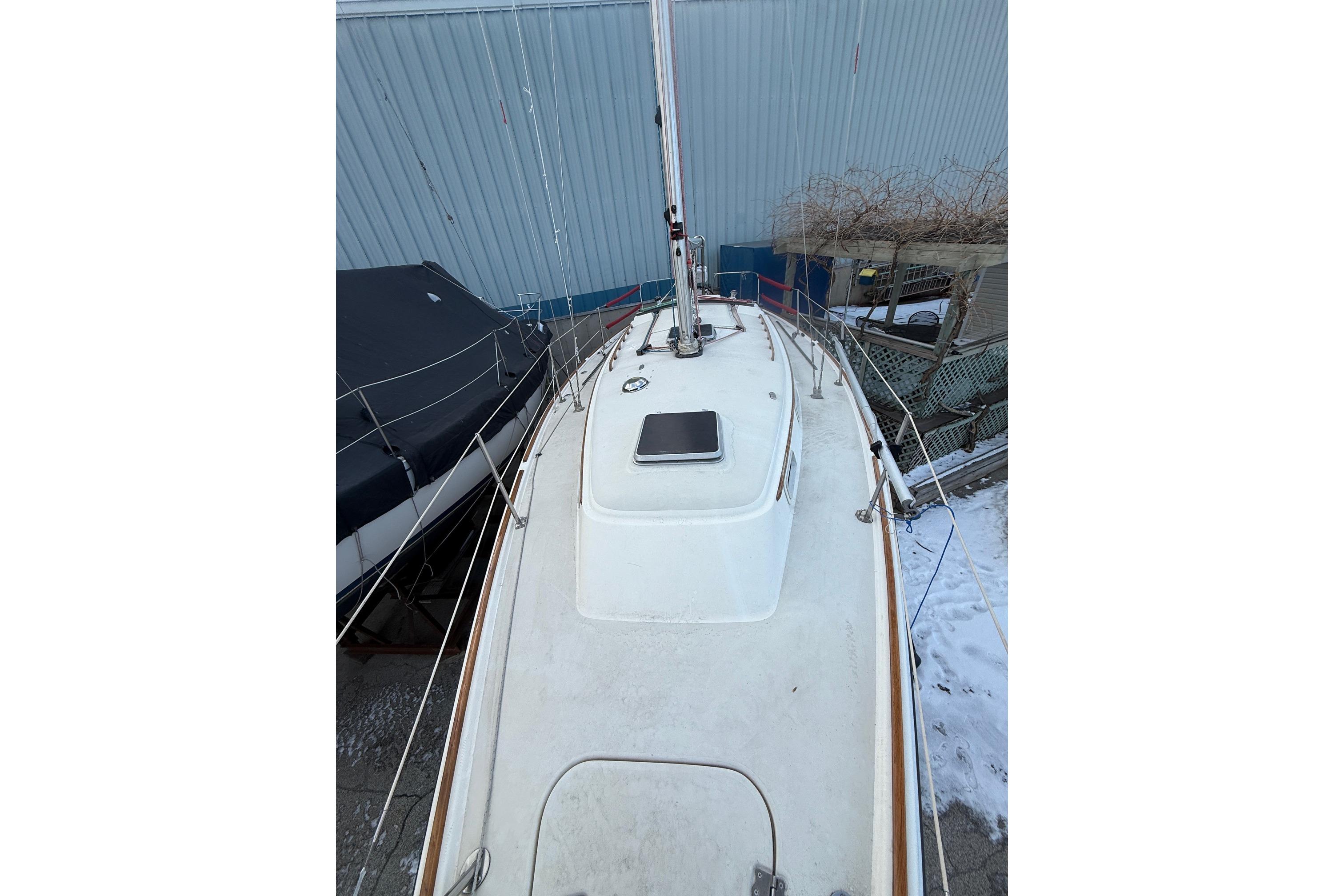 1986 Pearson 303 sailboat deck view, docked with snow on the ground.
