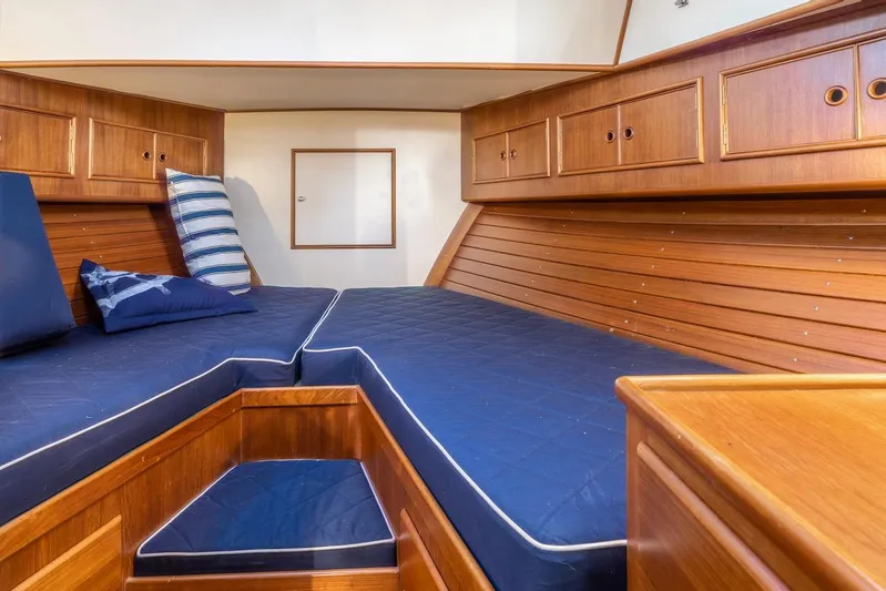 Salty Witch Yacht Photos Pics Cabin interior of 1998 Grand Banks 38 Eastbay EX with blue cushions and wooden finish.